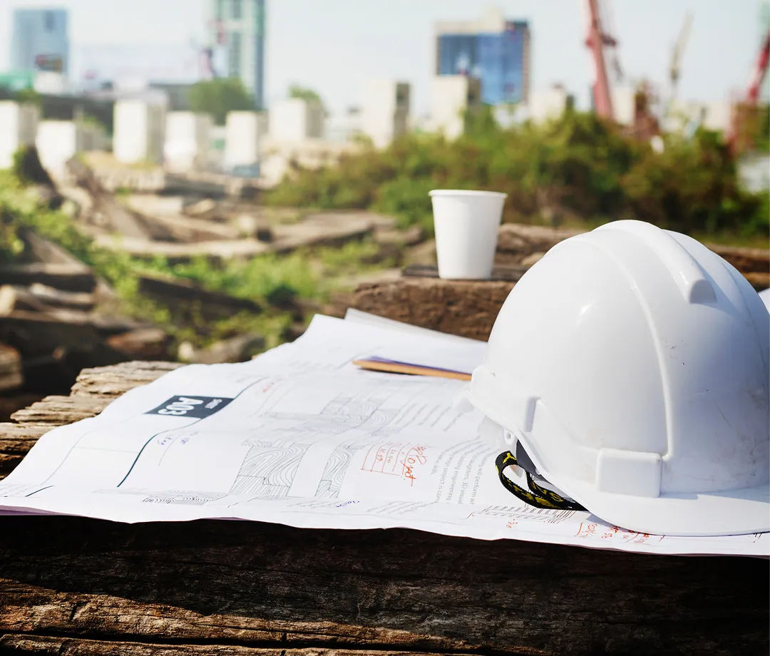 Safety helmet on construction blueprints